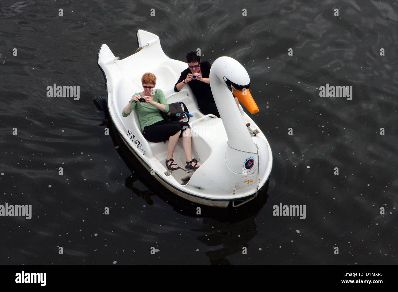 A swan pedal boat with tourists on the river Vltava Czech Republic