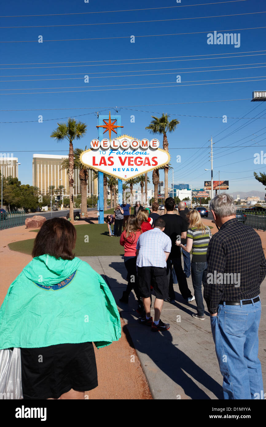 visitors waiting in line to take photos at the welcome to fabulous Las Vegas sign Nevada USA Stock Photo