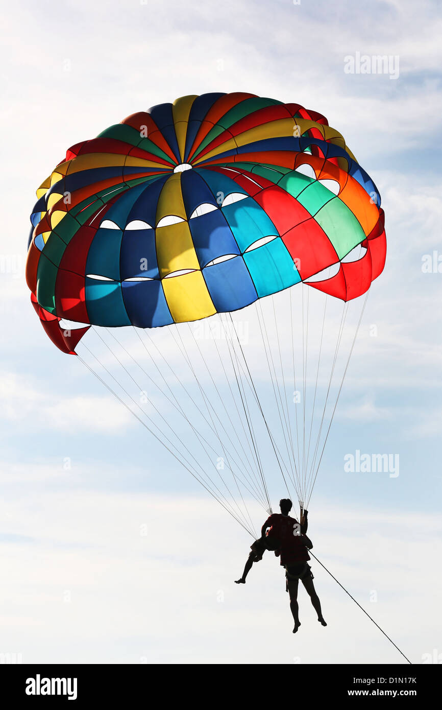 Tourists parascending with a parachute on Patong Beach, Phuket, Thailand Stock Photo