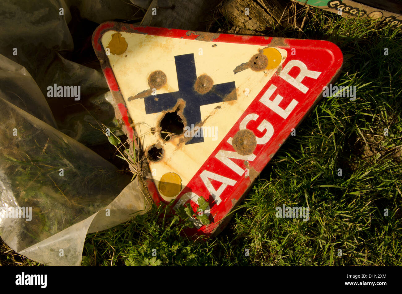 Rusty Danger sign with bullet holes Stock Photo