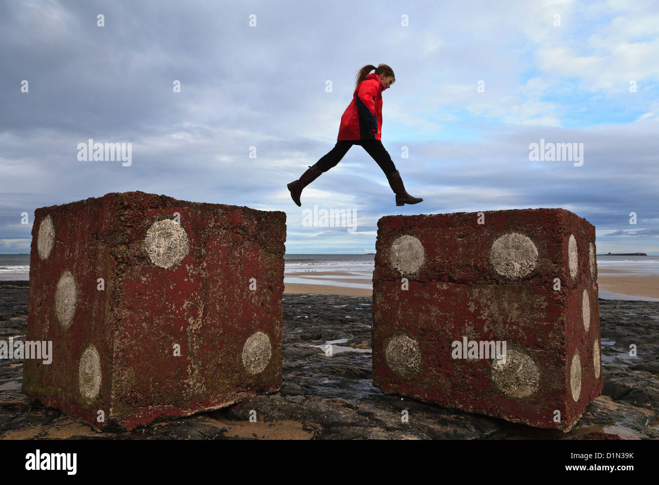 Young girl jumping between concrete blocks (wartime anti tank defences