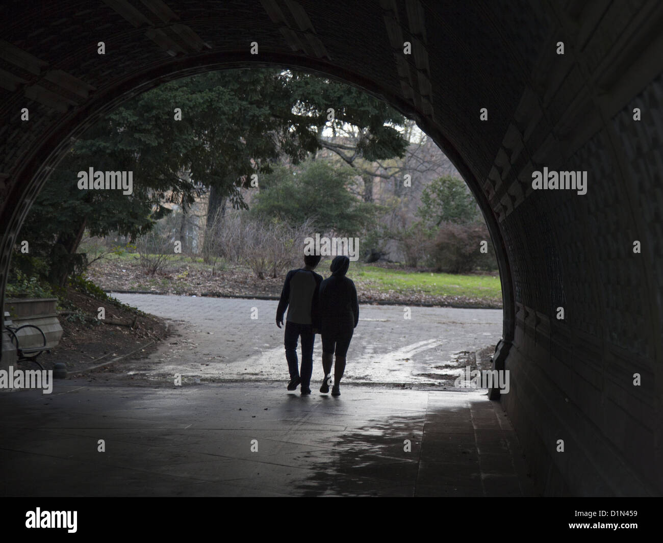 Couple walks under one of the many bridges in Prospect Park, Brooklyn, NY. Stock Photo