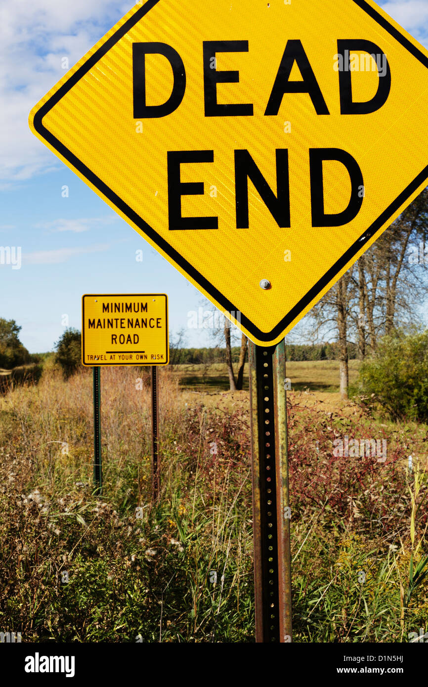 Dead End sign with Minimum Maintenance Road sign behind. Stock Photo