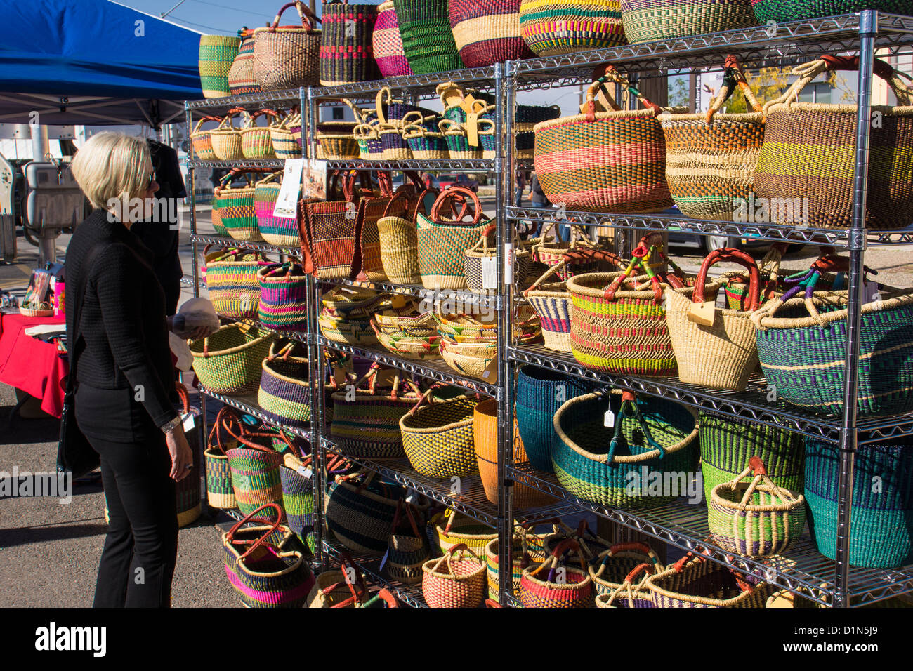 Woman shopping at handmade basket display at Santa Fe, NM farmer's market Stock Photo