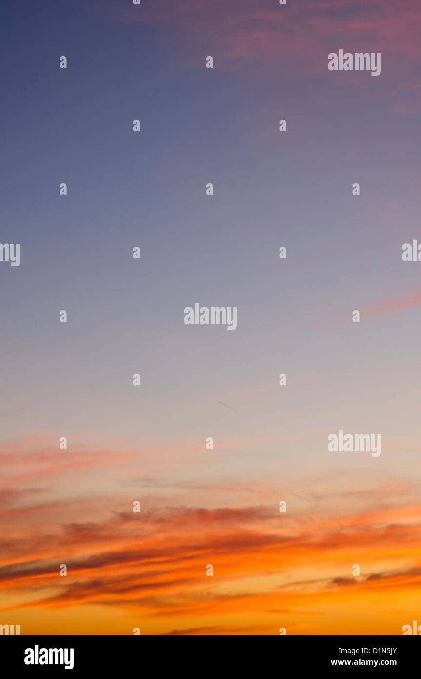 Dramatic orange clouds and blue sky at sunset Stock Photo - Alamy