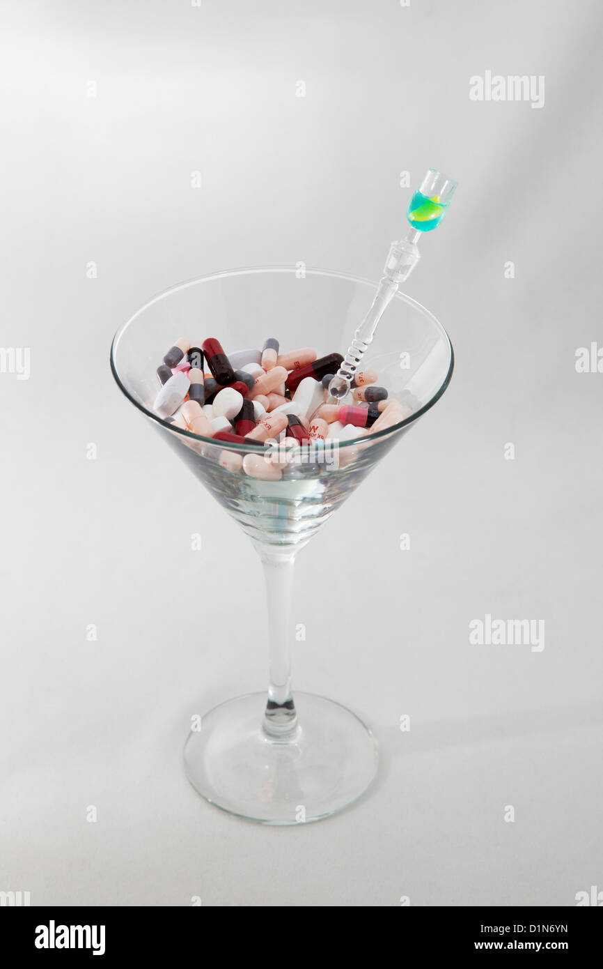Prescription pills, tablets, capsules and martini glass. White