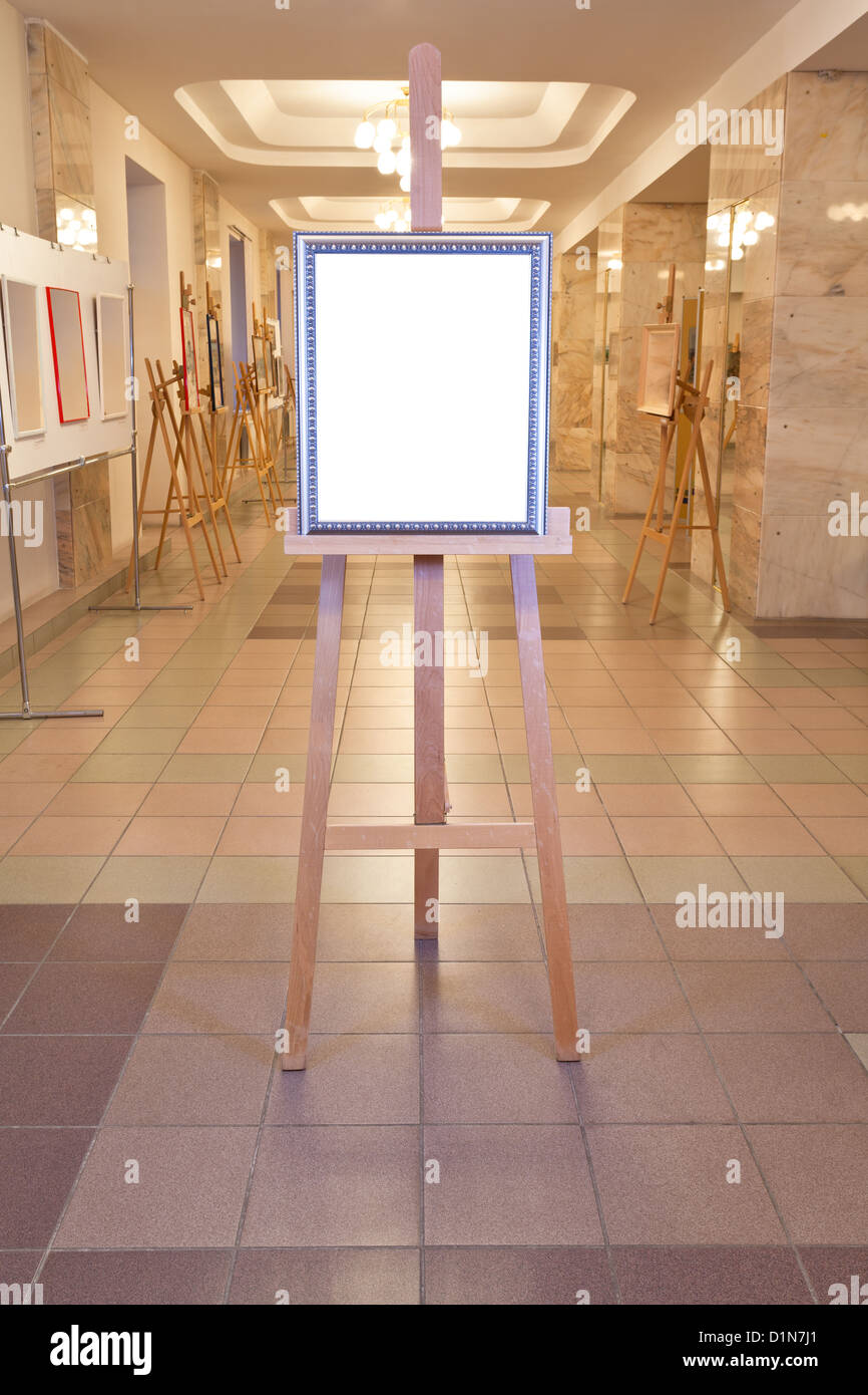 silver picture frame with white cut out canvas on easel in art gallery hall Stock Photo