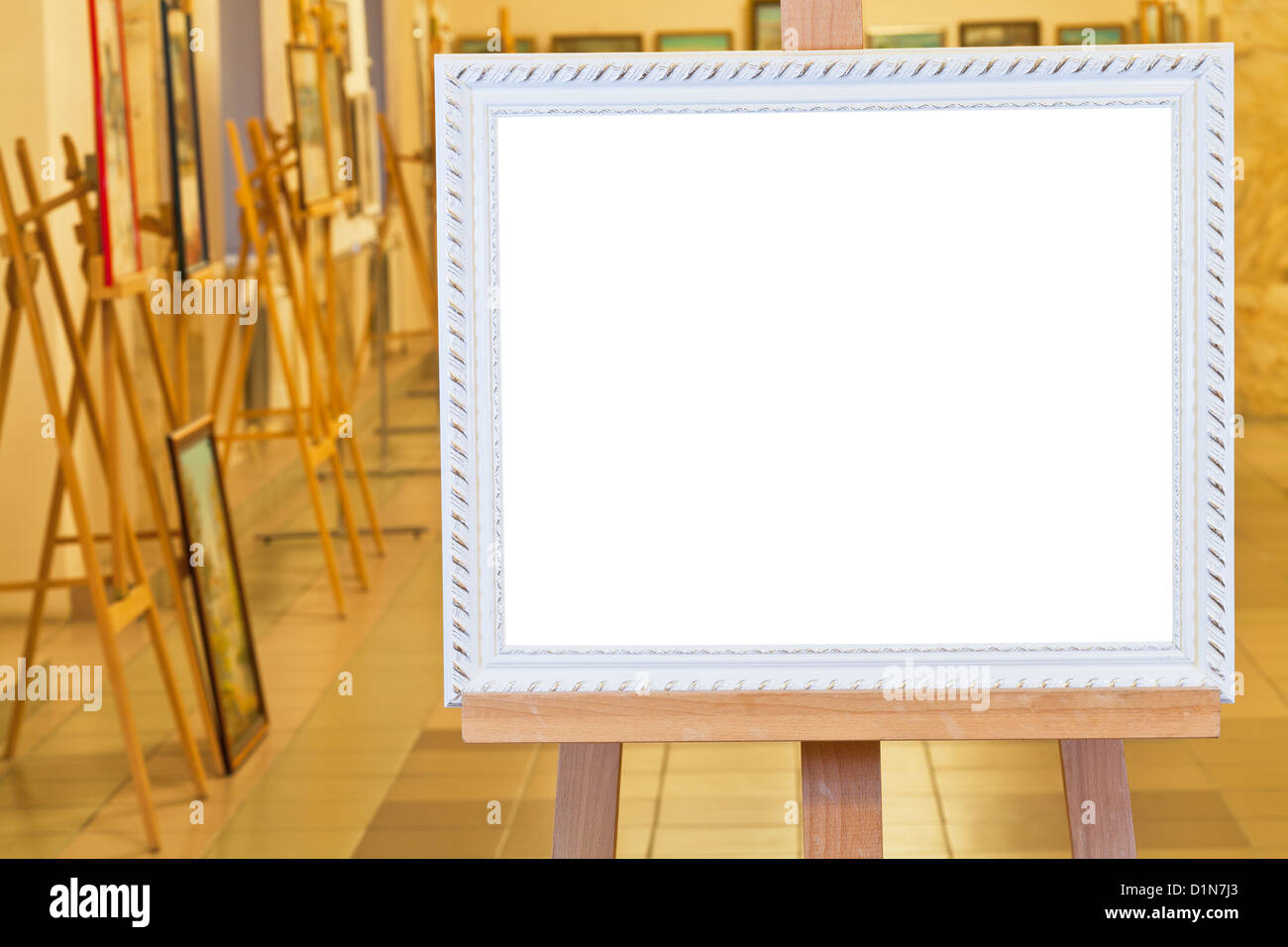 white picture frame with white cut out canvas on easel in gallery hall Stock Photo