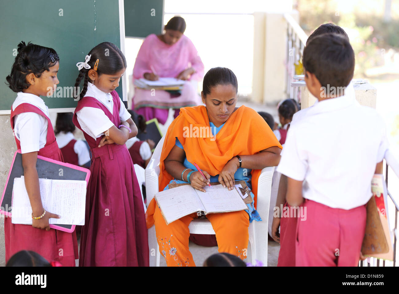 Indian school teacher with children Andhra Pradesh South India Stock Photo