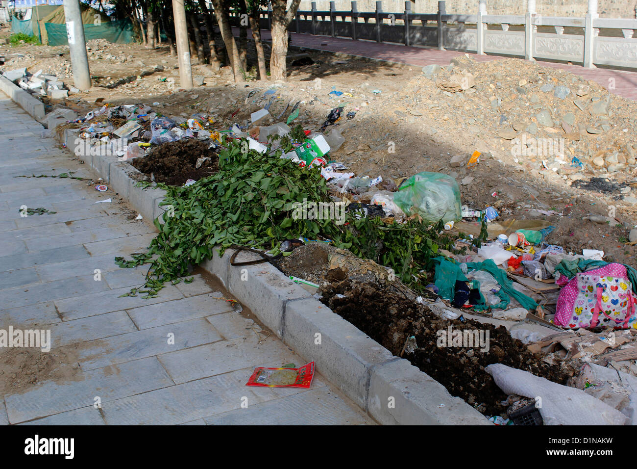 polluted side road in the tibetan town in xiahe county, china Stock