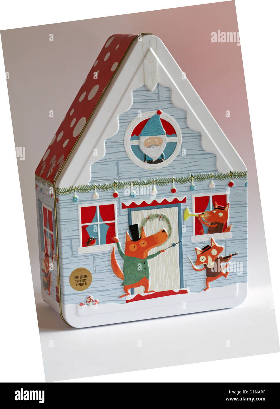 Decorative biscuit tin in shape of house isolated on white background