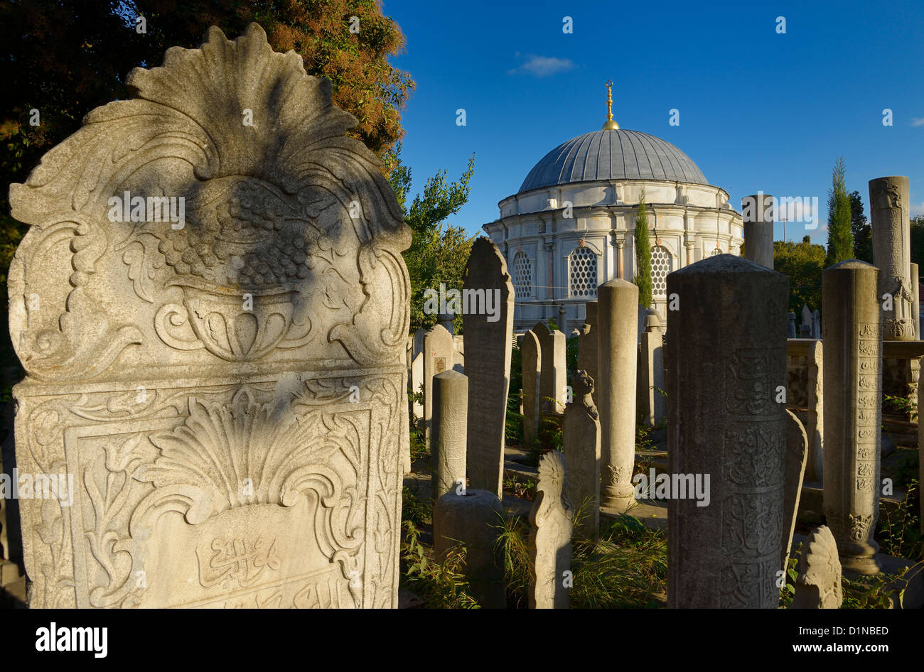 Carving on grave stones and Mausoleum in the Ottoman cemetery at Eyup Sultan Mosque Istanbul Turkey Stock Photo