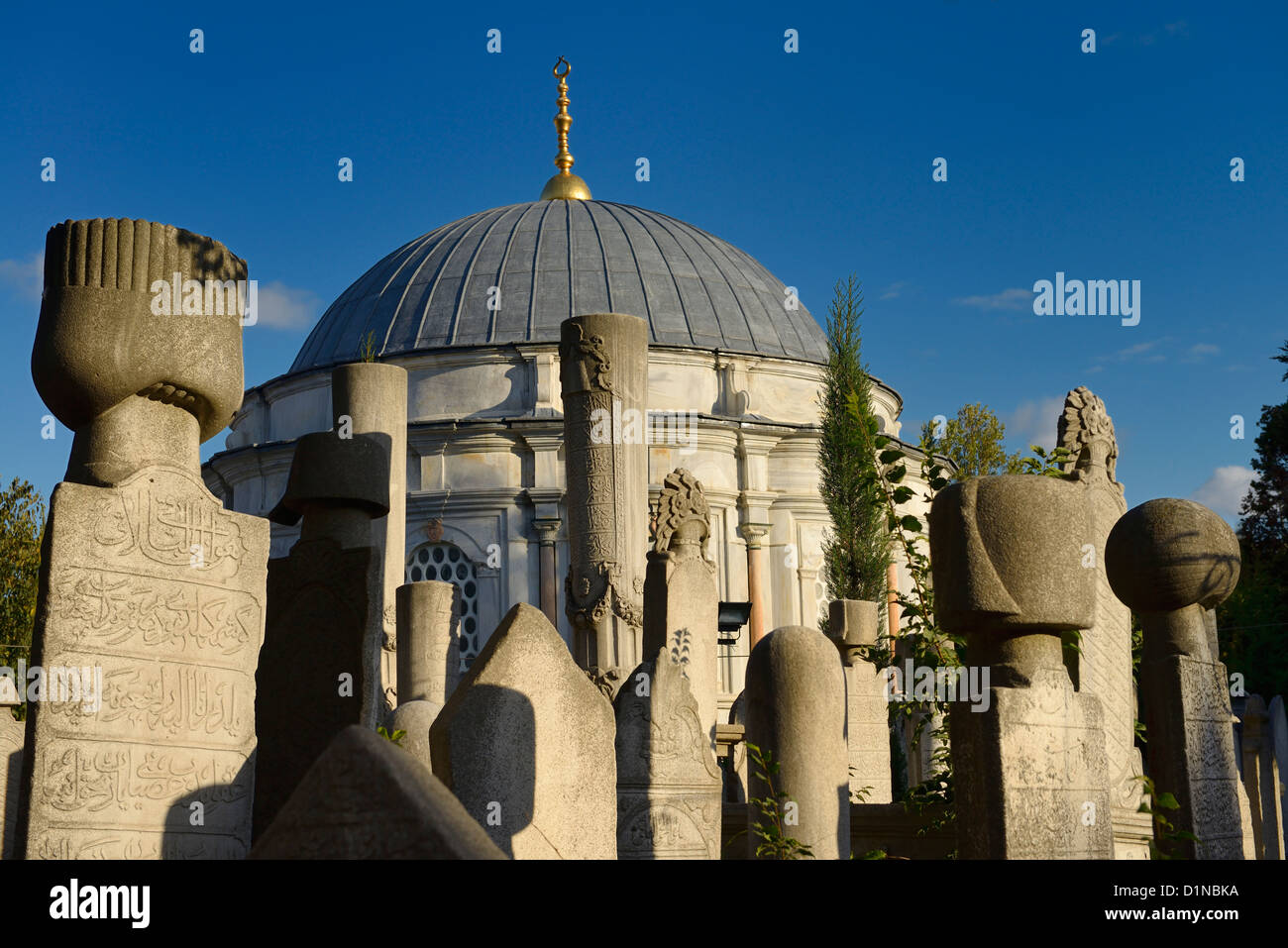 Sun on grave stones and Mausoleum in the Ottoman cemetery at Eyup Sultan Mosque Istanbul Turkey Stock Photo