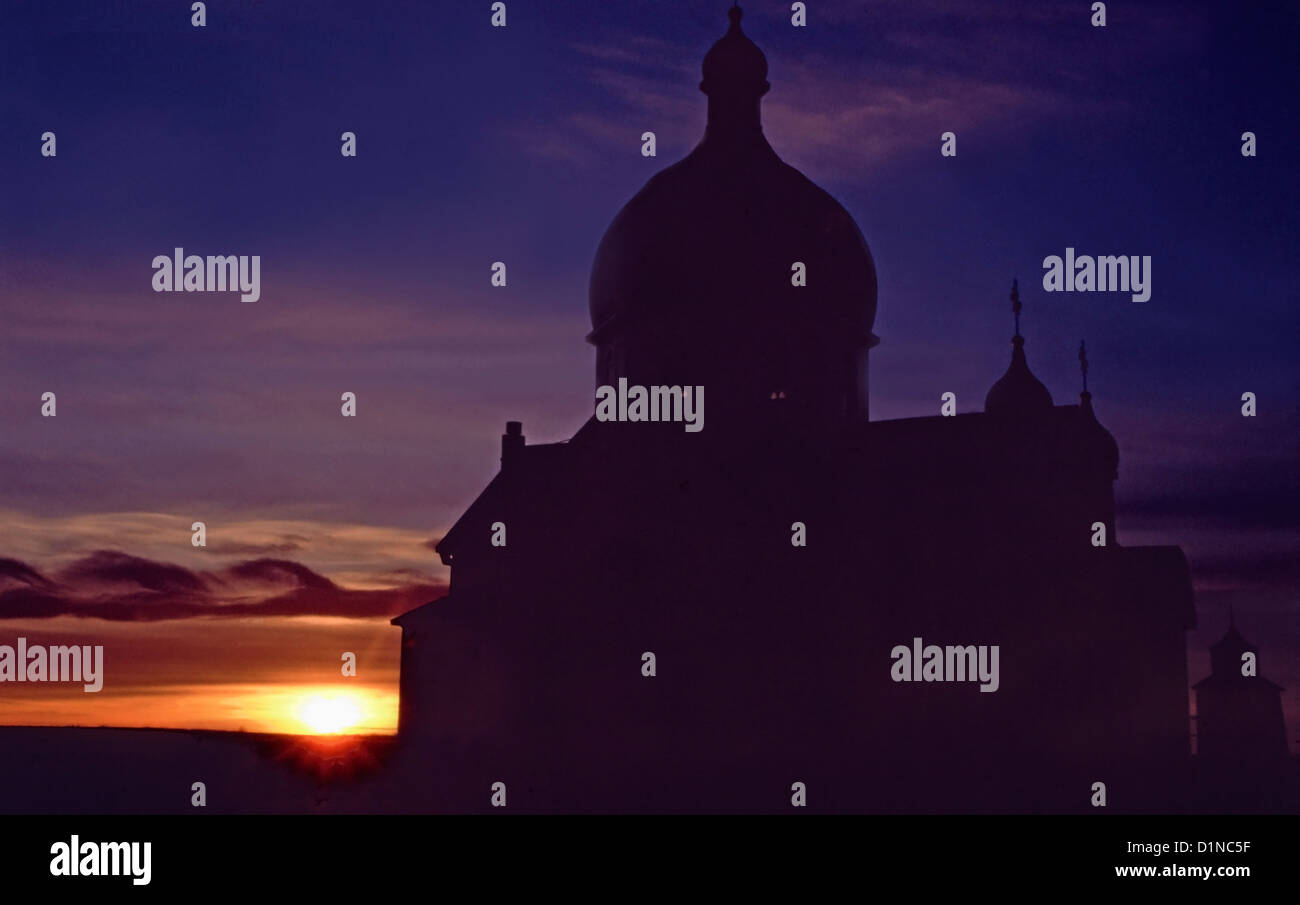A silhouette of a Ukrainian Orthodox church at sunset with swirling cloud formation, Saskatchewan, Canada Stock Photo