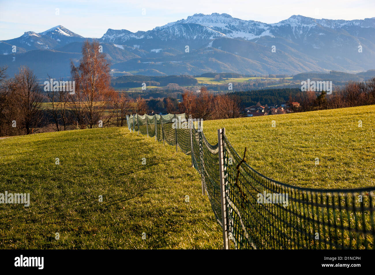 Snow fence with Kampenwand in the background, Chiemgau Upper Bavaria Germany Europe Stock Photo