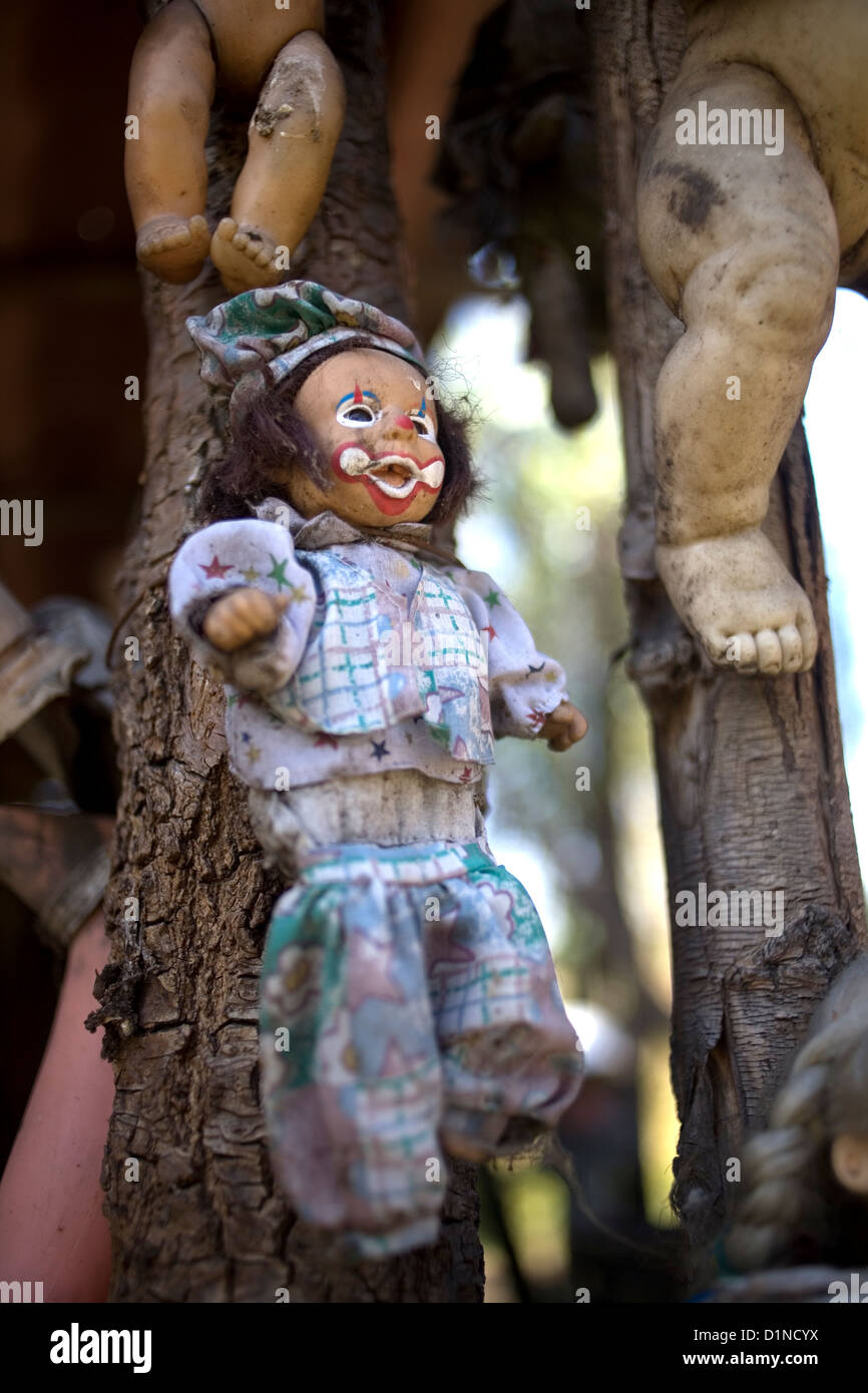 A clown doll hangs on a building on the Island of the Dolls in