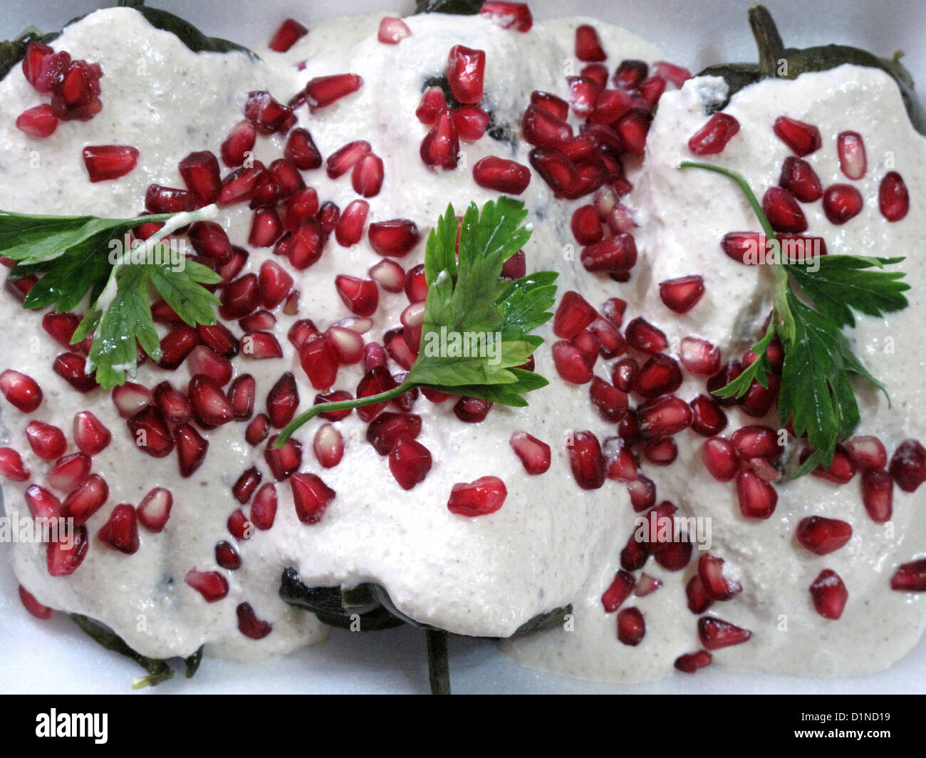 Dinner of Chiles en Nogada (Chilies in Walnut Sauce), a traditional Mexican dish, in a home of Mexico City, Mexico Stock Photo