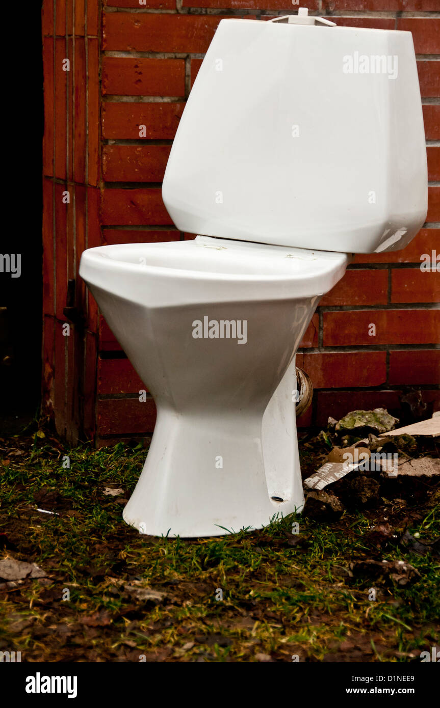 a toilet seat abandoned as waste Stock Photo