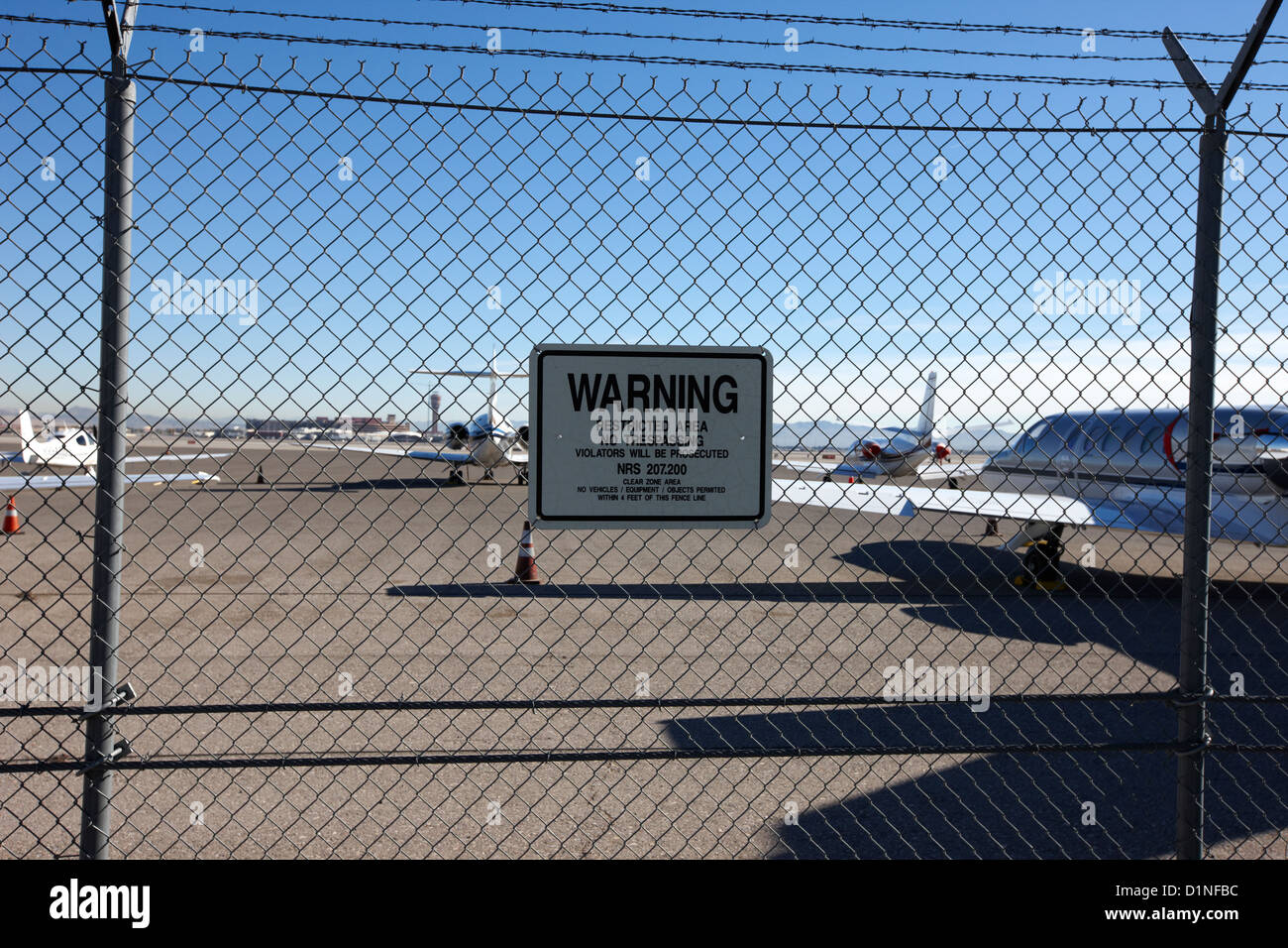 security chain link fencing with warning restricted area sign on the
