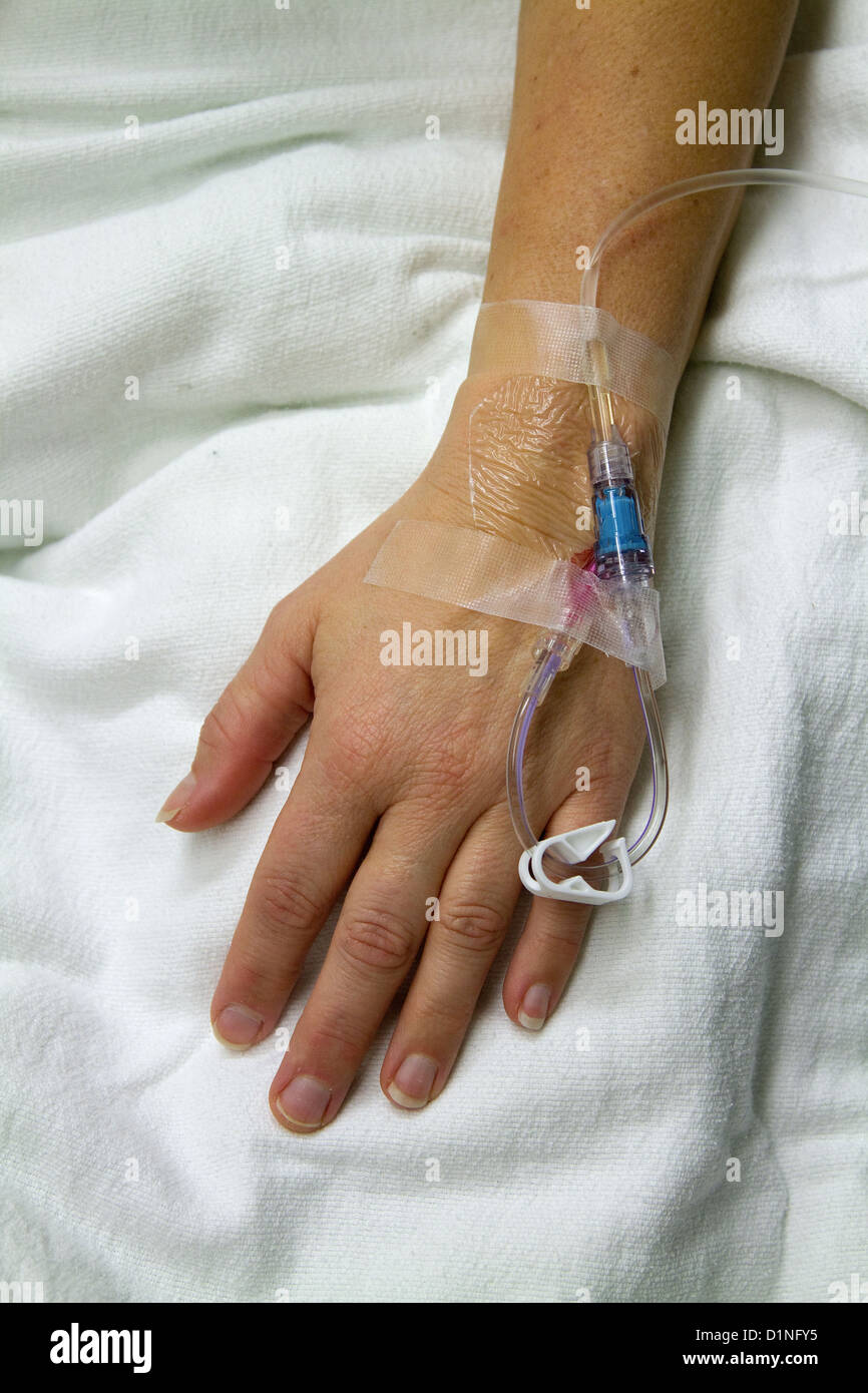 Intravenous, patient receives care in recovery while receiving an iv, intravenous, drip. Stock Photo