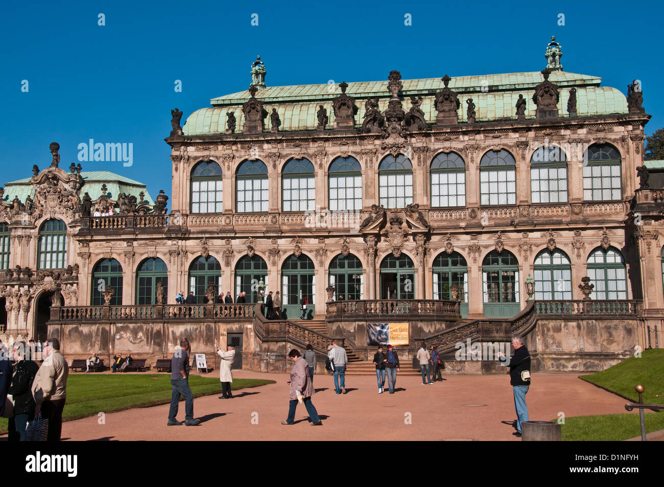 Interior inner courtyard of Zwinger Palace with tourists and a large palace pavilion in the background, Dresden Germany Stock Photo