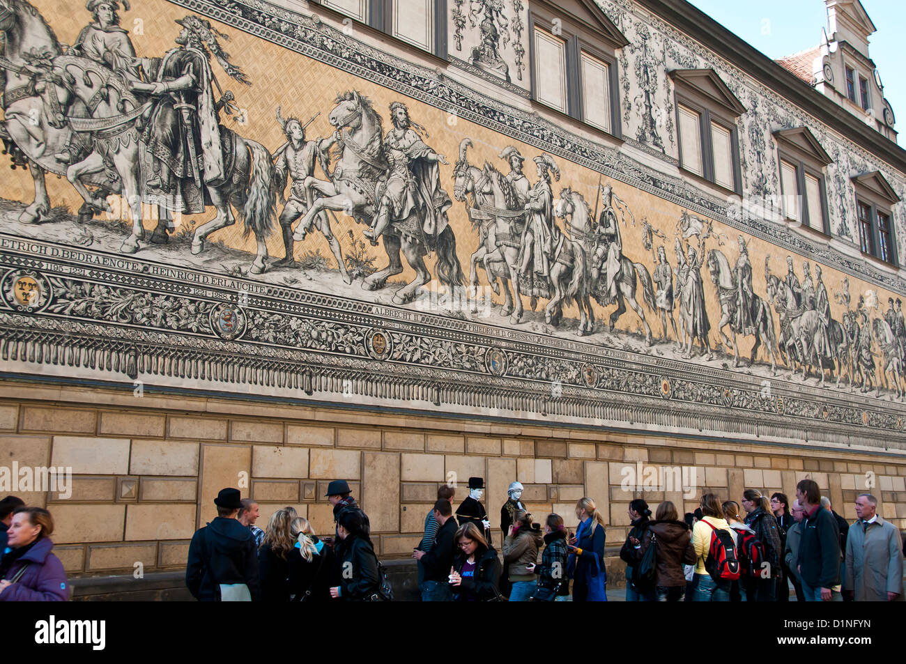Furstenzug or the Procession of Princes exterior landmark mural with tourists, Dresden, Germany Stock Photo