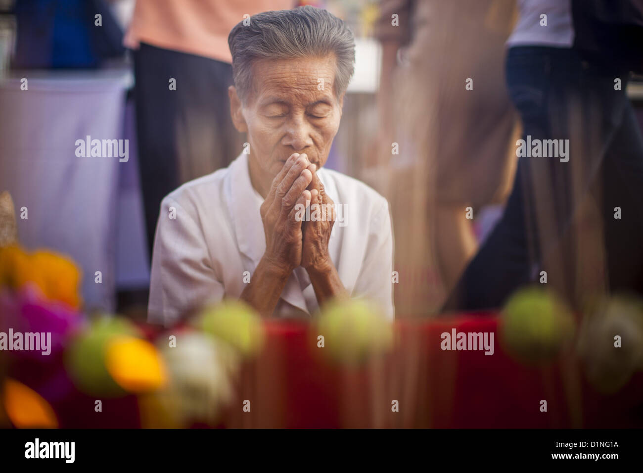 Jan. 1, 2013 - Bangkok, Thailand - A man prays during a special merit making ceremony at Bangkok City Hall New Year's morning. Many Thais go to Buddhist temples and shrines to ''make merit'' for the New Year. The traditional Thai New Year is based on the lunar calender and is celebrated in April, but the Gregorian New Year is celebrated throughout the Kingdom. (Credit Image: © Jack Kurtz/ZUMAPRESS.com) Stock Photo