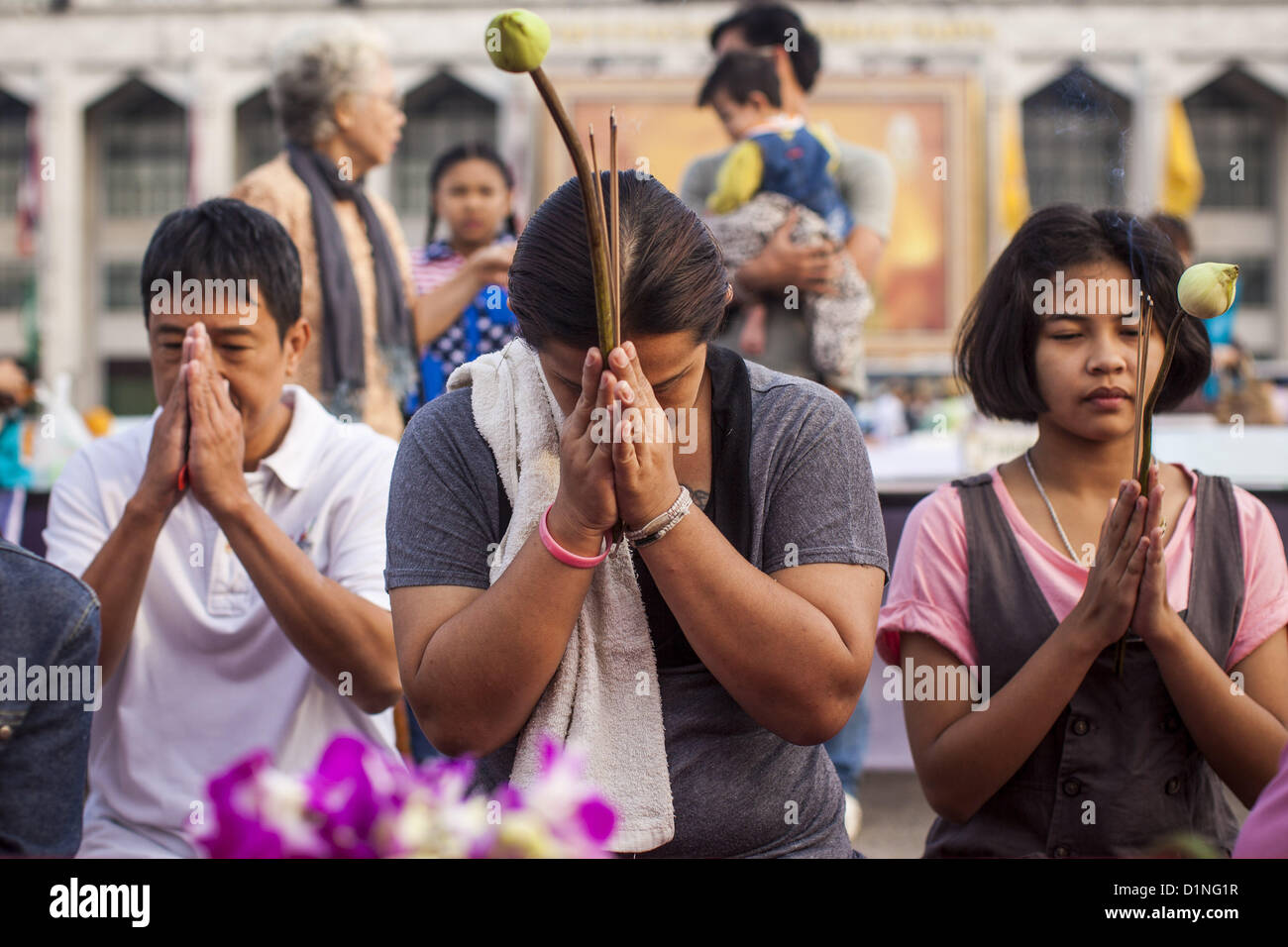 Jan. 1, 2013 - Bangkok, Thailand - People pray at a shrine during a special merit making ceremony at Bangkok City Hall New Year's morning. Many Thais go to Buddhist temples and shrines to ''make merit'' for the New Year. The traditional Thai New Year is based on the lunar calender and is celebrated in April, but the Gregorian New Year is celebrated throughout the Kingdom. (Credit Image: © Jack Kurtz/ZUMAPRESS.com) Stock Photo