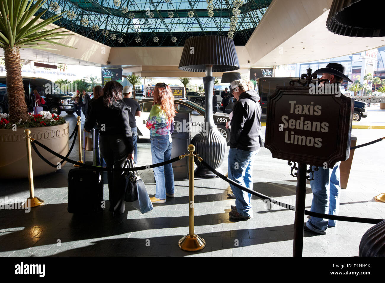 people queuing for taxis sedans and limos in valet area of hotel casino Las Vegas Nevada USA Stock Photo