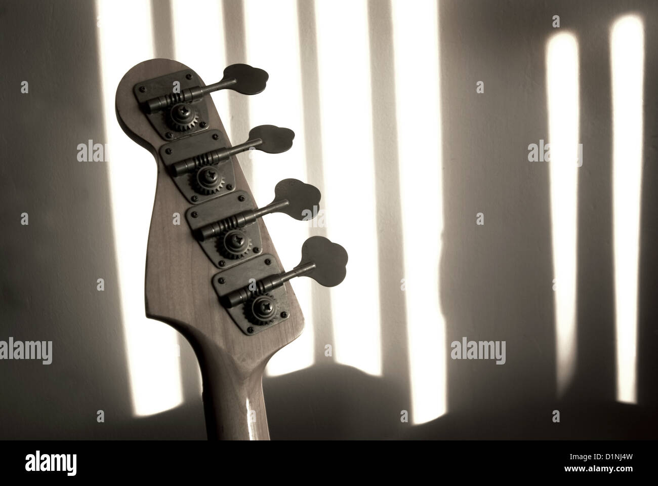Bass guitar tuning head stock with shadows (music,jazz,blues,funk,rock concept) Stock Photo