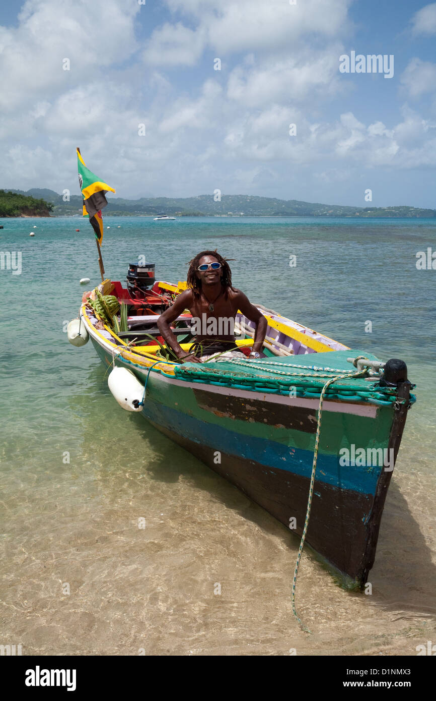 A rastafarian local water taxi man offers a ride; Windjammer beach, St Lucia, Caribbean, West Indies Stock Photo