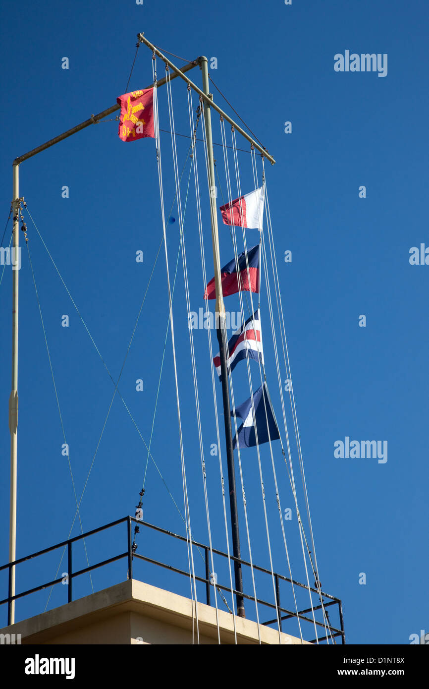 Ships flags on a ships lanyard against a blue sky Stock Photo