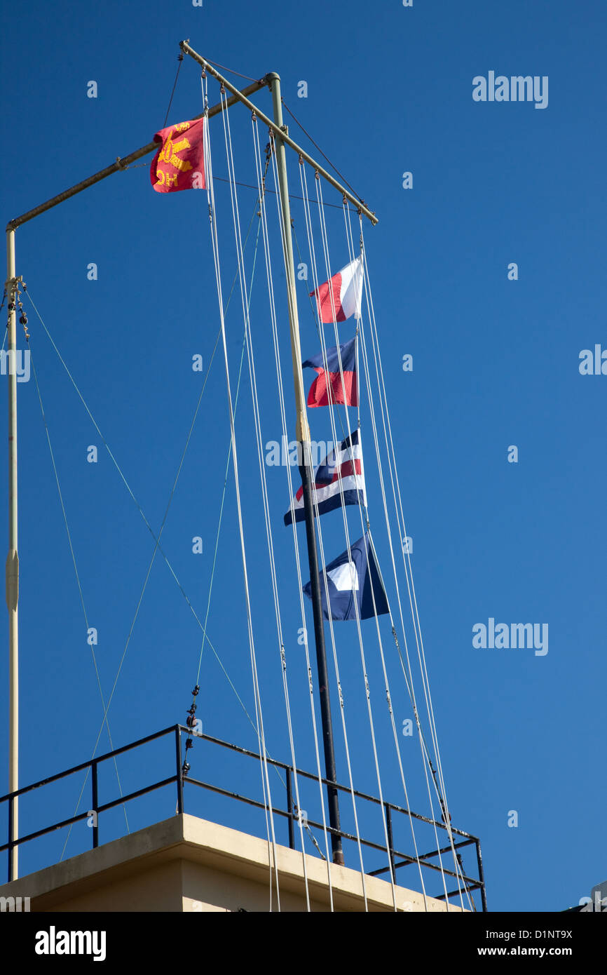 Ships flags on a ships lanyard against a blue sky Stock Photo