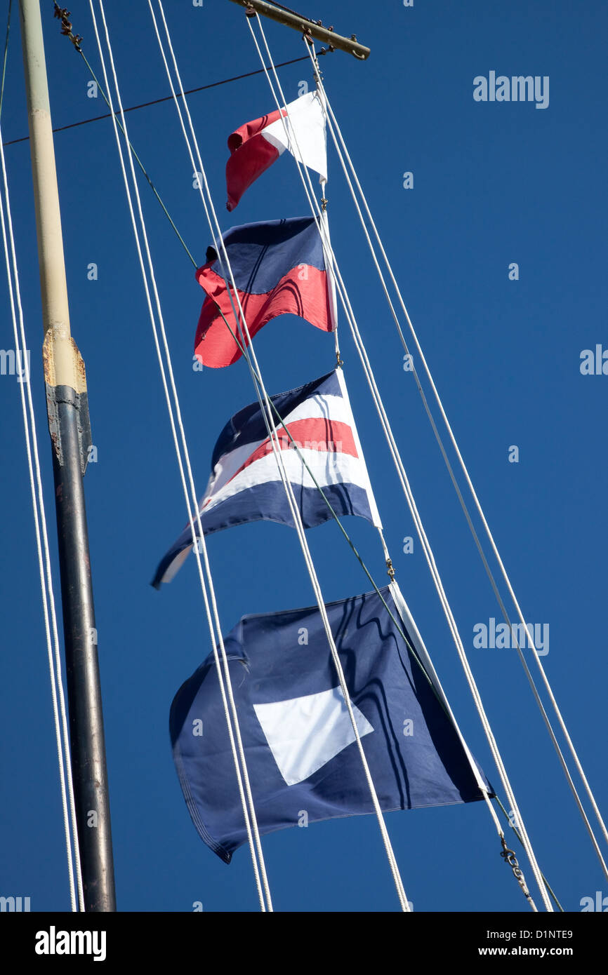 Ships flags on a ships lanyard against a blue sky Stock Photo Alamy
