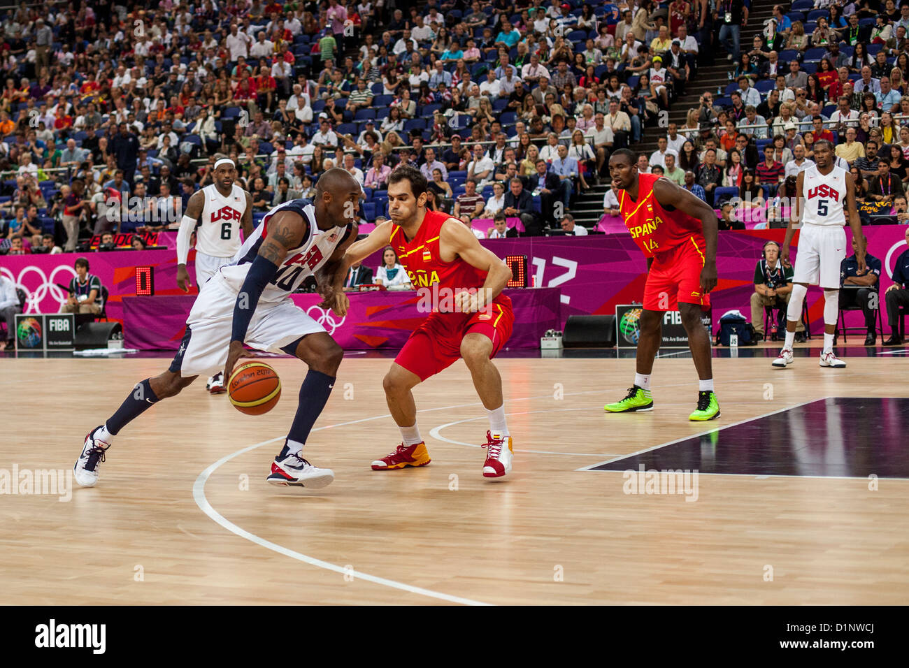 United States' Kevin Durant (C) and Kevin Love (R) cheer a foul on Spain's  Pau Gasol who knocked Chris Paul to the floor during the USA-Spain Men's  Basketball Gold Medal Medal game