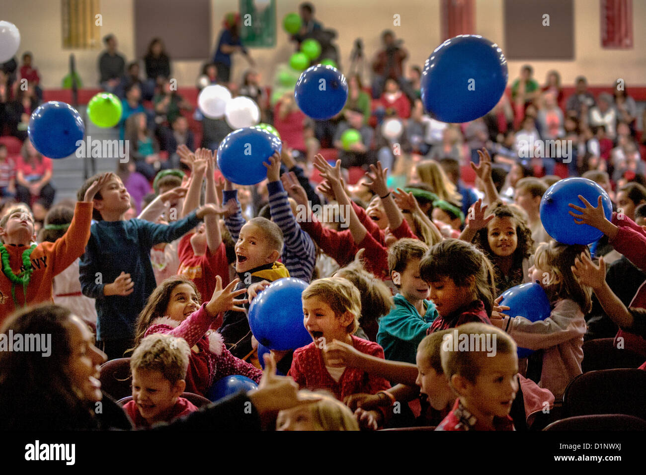 The audience at a Christmas pageant at the California School for the Deaf in Riverside, CA, happily plays with balloons. Stock Photo