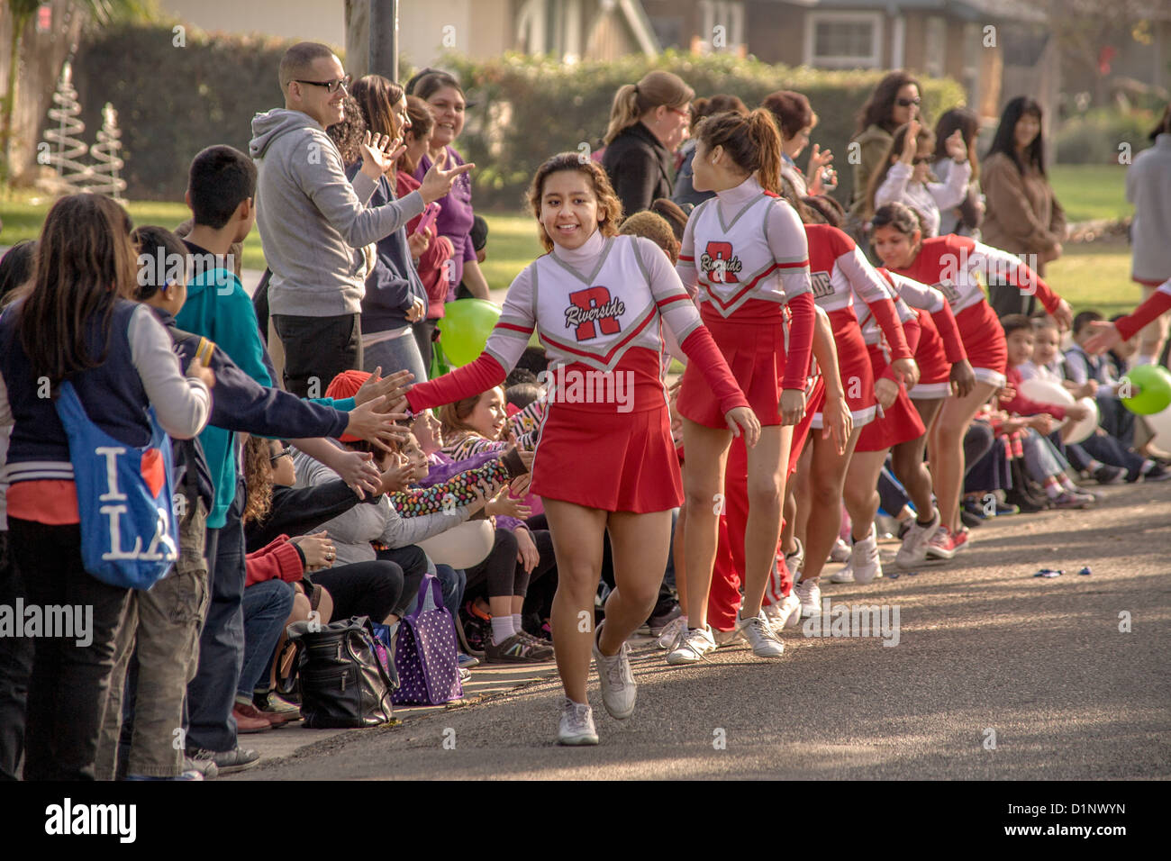 Team of deaf cheerleaders greets spectators while leading a Christmas parade at the California School for the Deaf, Riverside CA Stock Photo