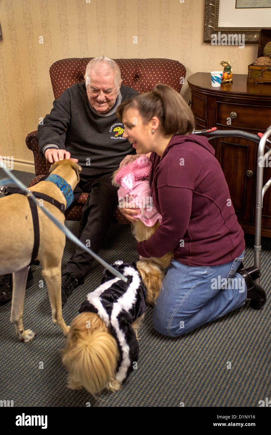 Volunteers bring therapy dogs in Halloween costumes to a retirement