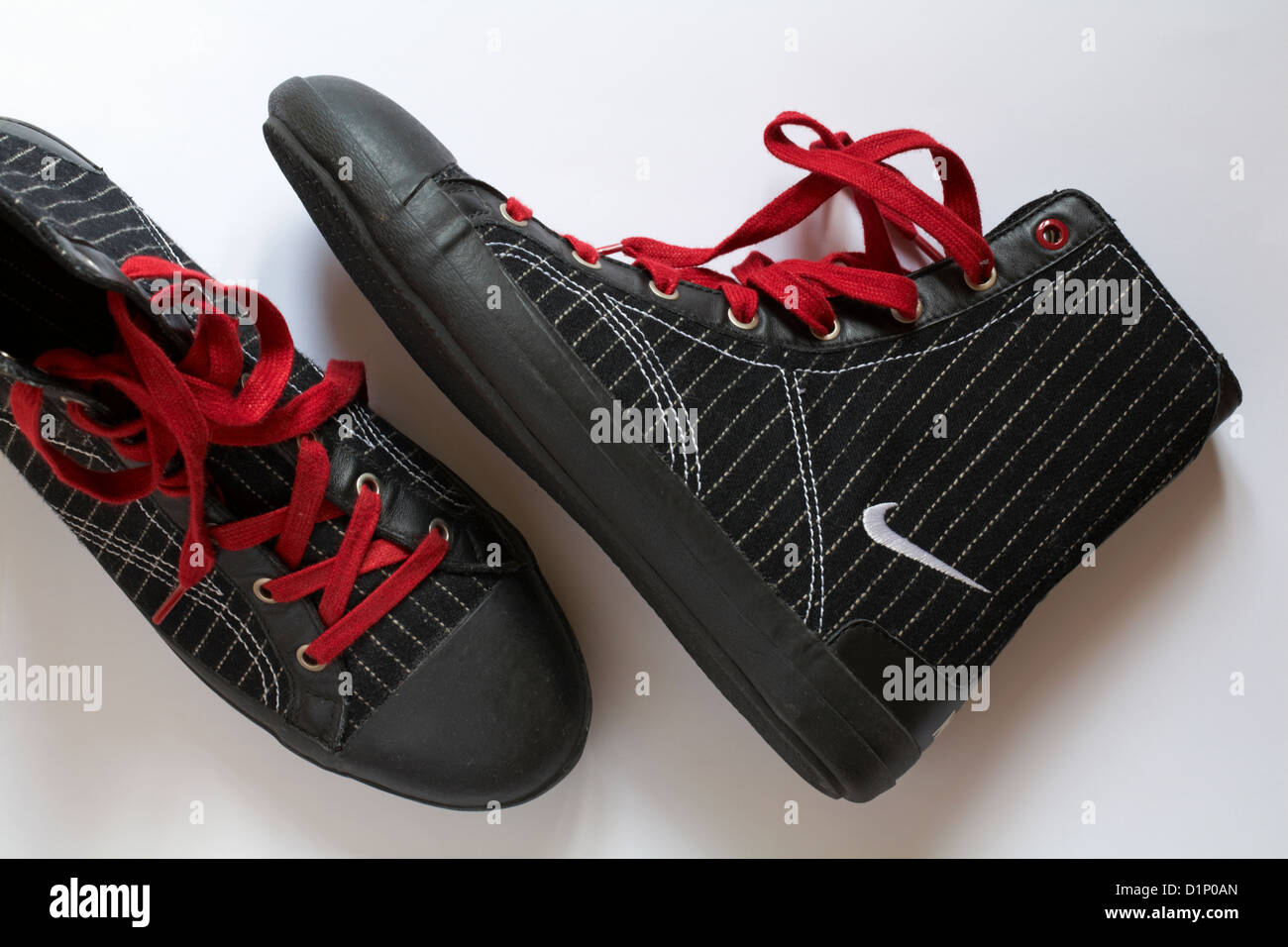 Pair of boots with Nike logo and red laces set on white background Stock  Photo - Alamy
