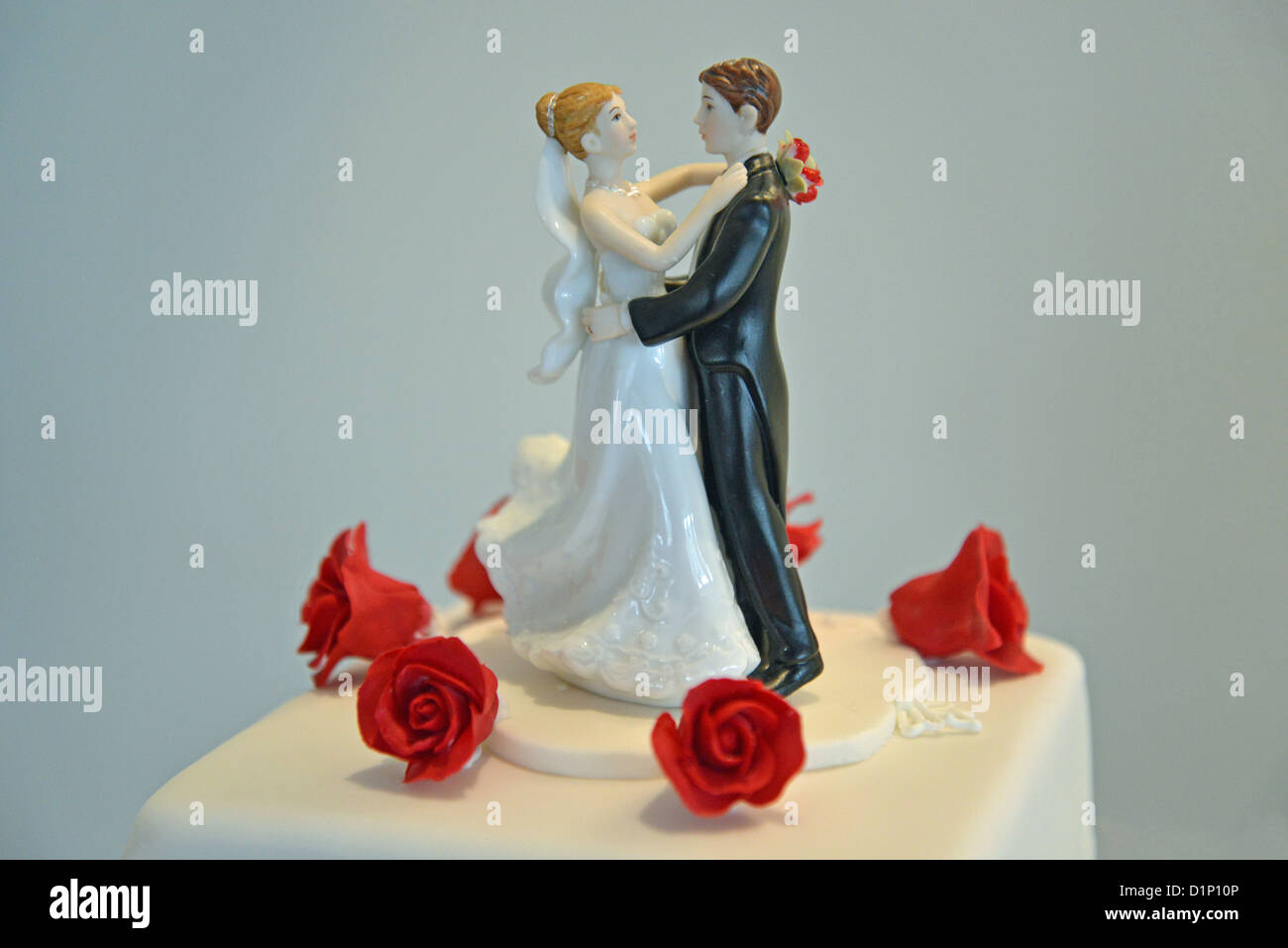 Bride and groom figure on top of wedding cake, Staines-upon-Thames, Surrey, England, United Kingdom Stock Photo