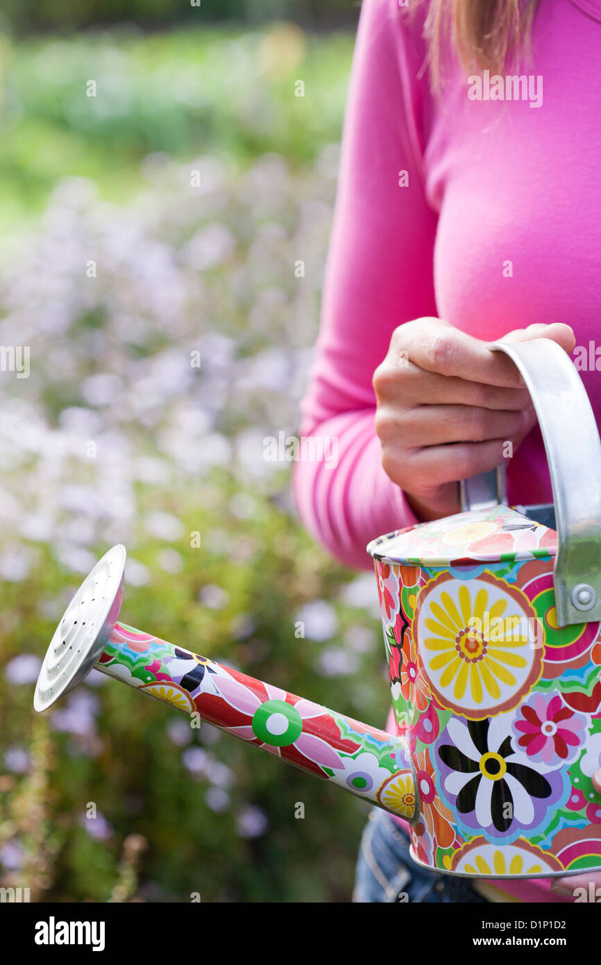 Woman with a painted watering can. Stock Photo