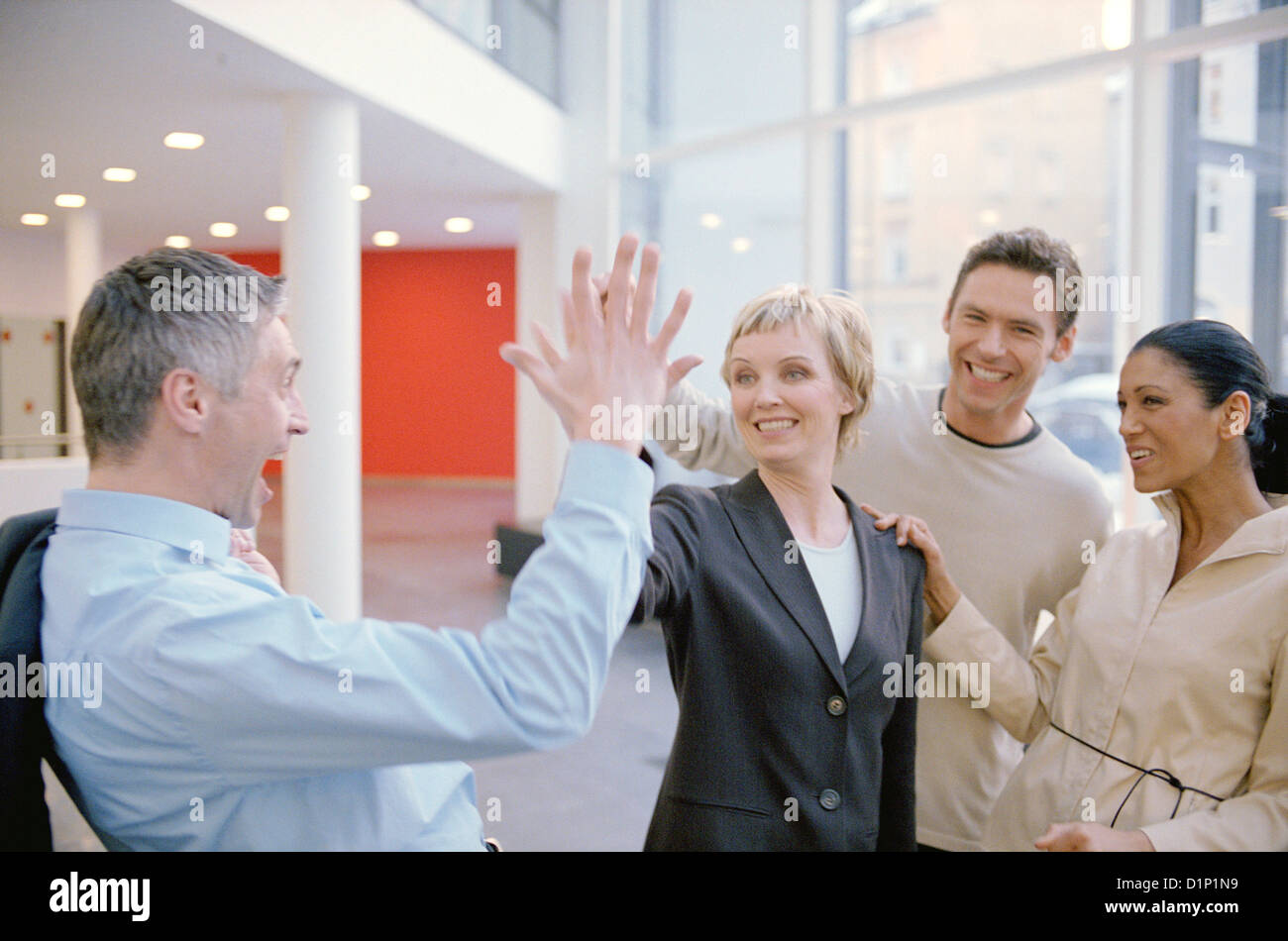 Two business people to give so a high five License free except ads and billboards Stock Photo