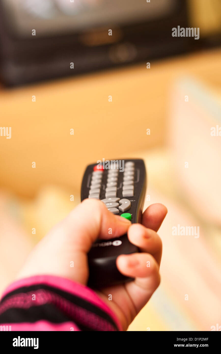 hand holding a television remote control Stock Photo