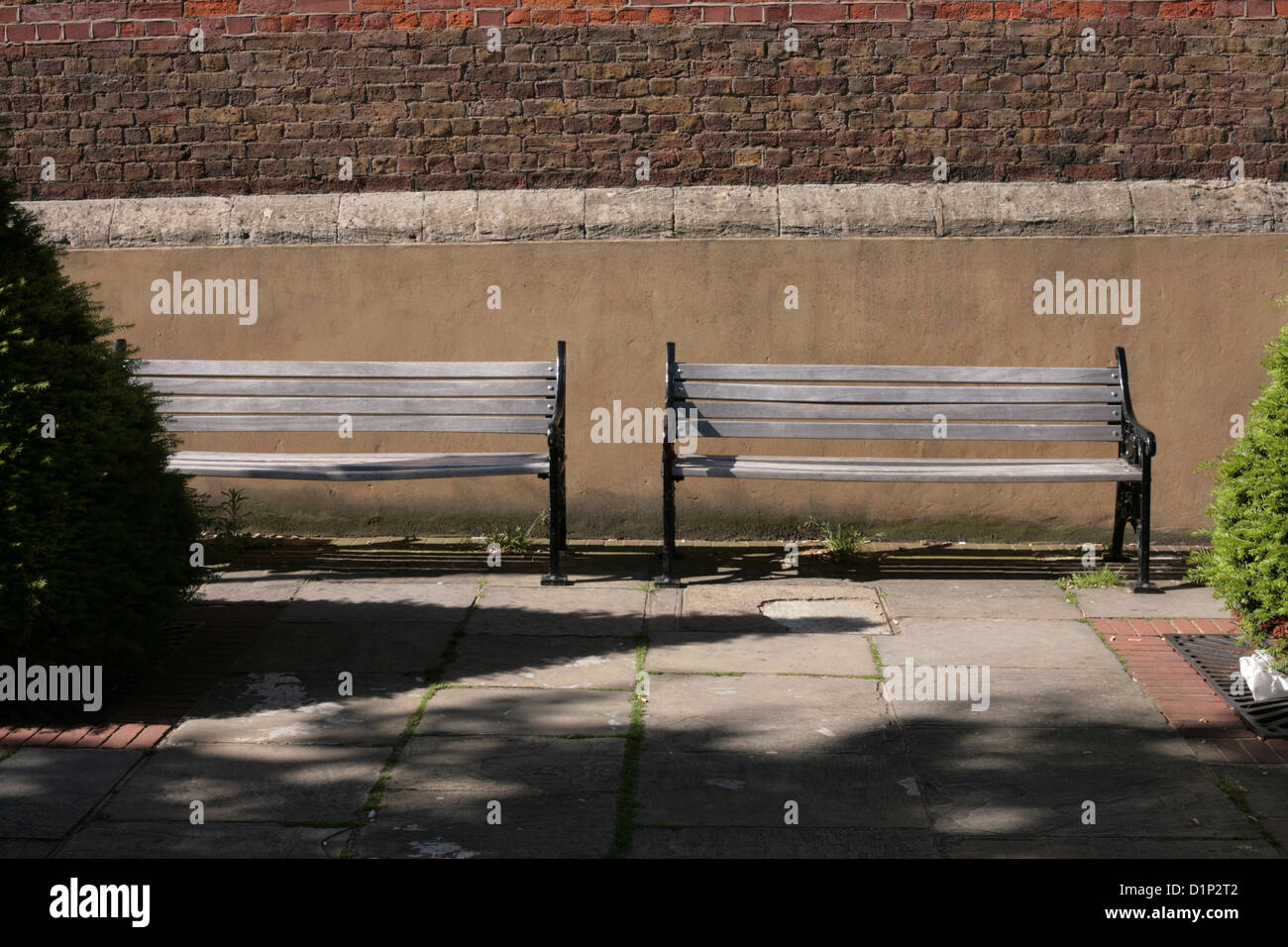 two empty park benches in the sunshine Stock Photo