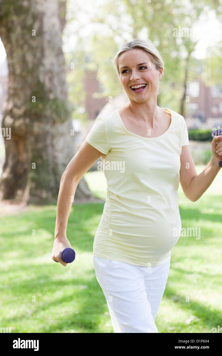 Pregnant woman exercising Stock Photo