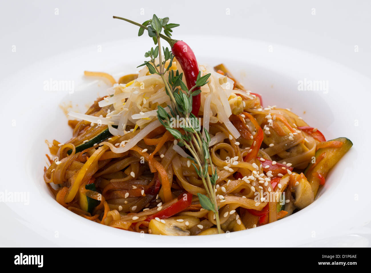 Spaghetti With Rice Model Rice spaghetti with vegetables on a white plate in a restaurant Stock ...