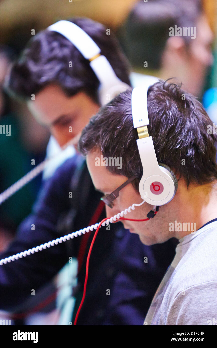 Visitors to a Gadget Show Live event try out Beats by Dr Dre headphones Stock Photo
