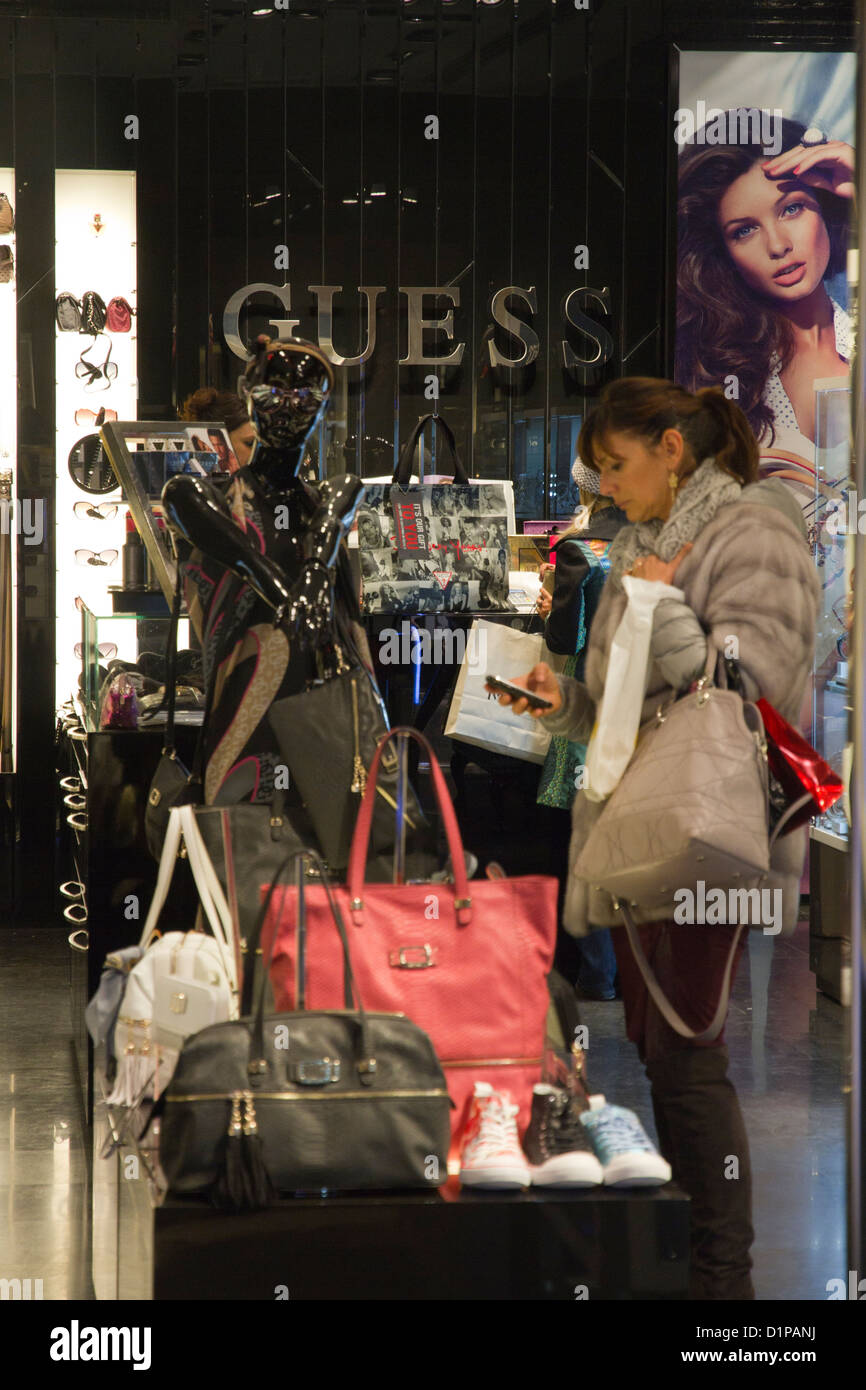 Woman shopping in Guess store in Rome Italy Stock Photo - Alamy