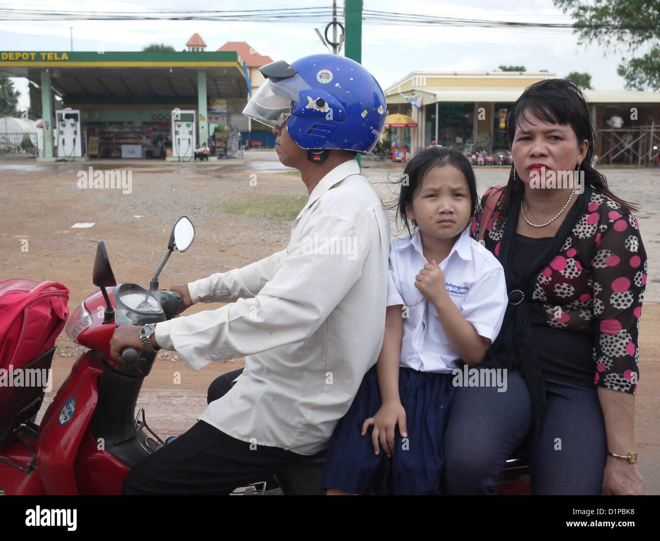 husband wife young girl riding scooter Cambodia Stock Photo