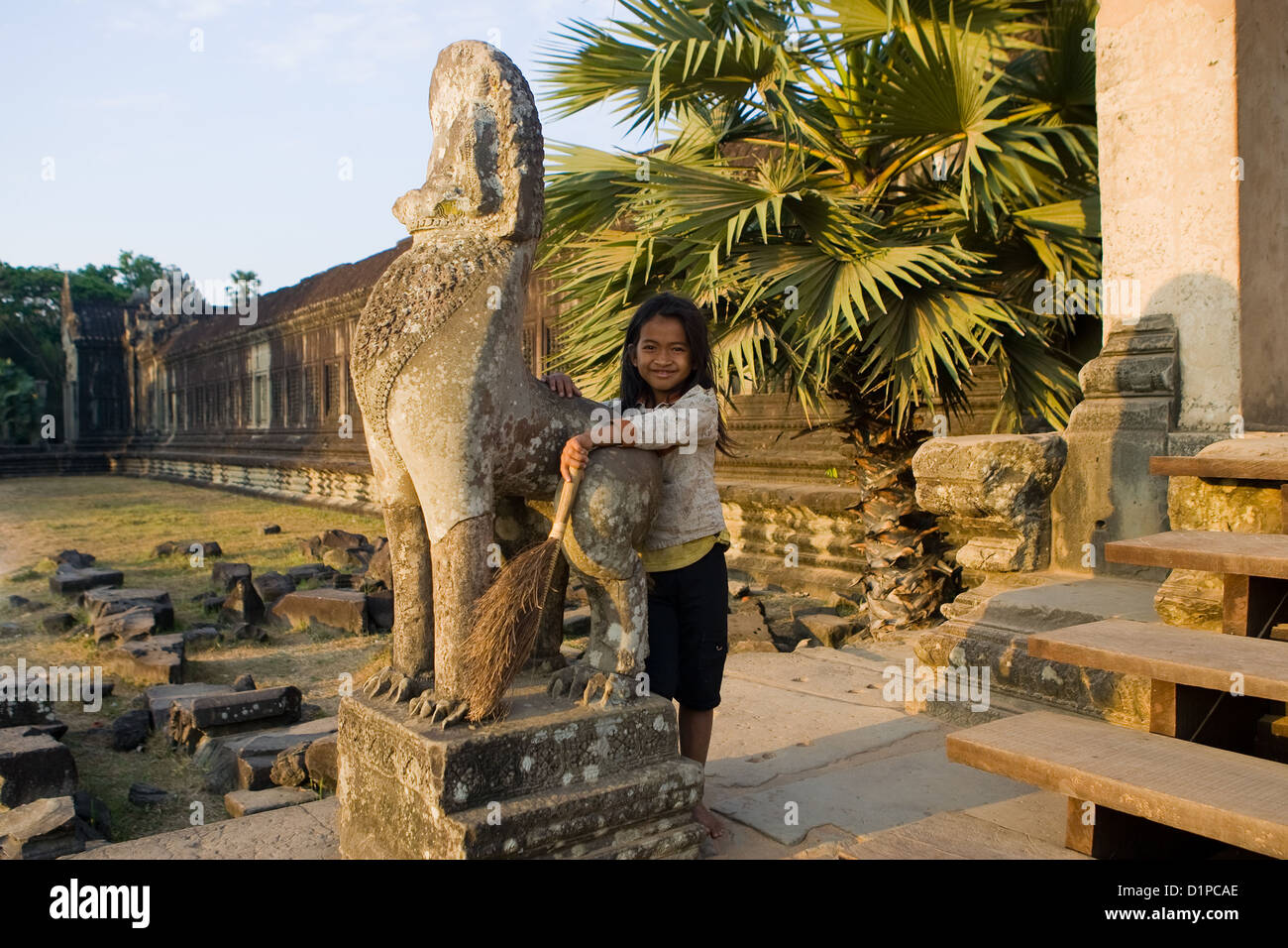 Girl with broom at Angkor Wat, Cambodia Stock Photo